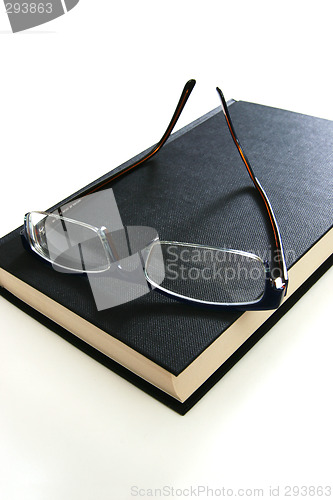 Image of eyeglasses on book