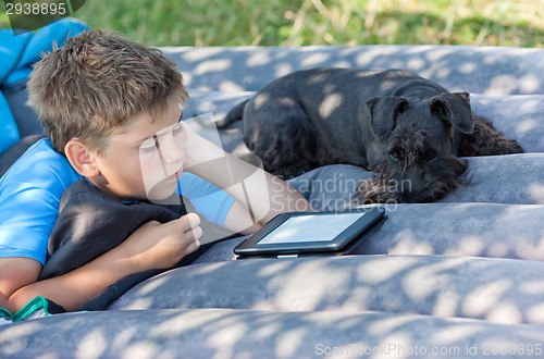 Image of Boy reads outdoors