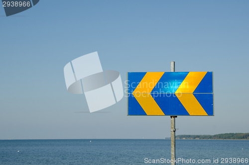 Image of Arrows roadsign by the coast