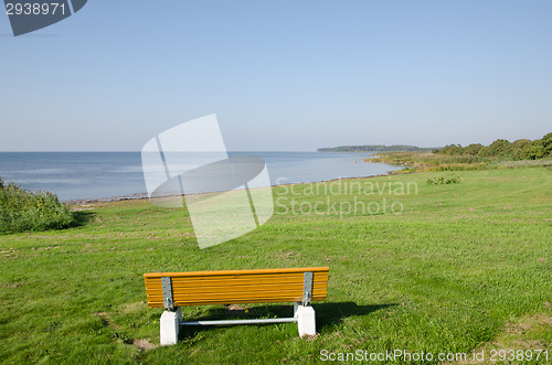 Image of Wooden bench by a calm bay