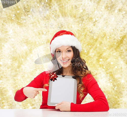 Image of smiling woman in santa hat with gift and tablet pc