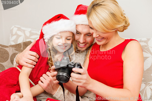 Image of family in santa helper hats looking at pictires