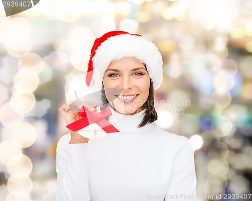 Image of smiling woman in santa helper hat and jingle bells