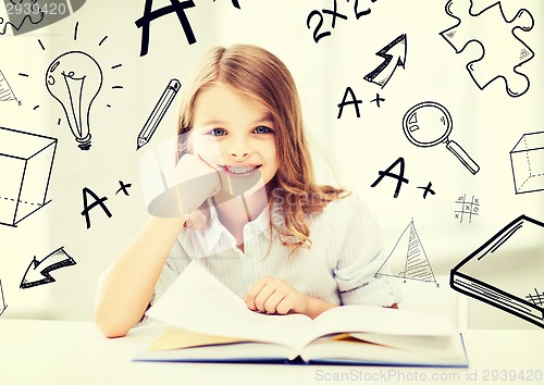 Image of little student girl studying at school