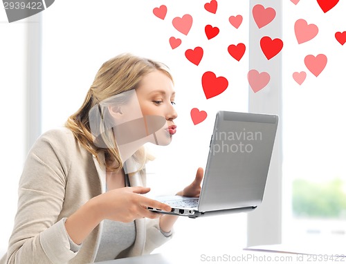 Image of woman sending kisses with laptop computer