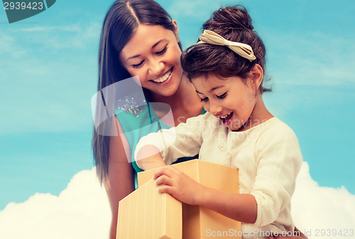 Image of happy mother and child girl with gift box