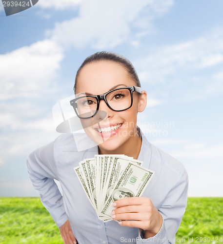 Image of smiling businesswoman with dollar cash money