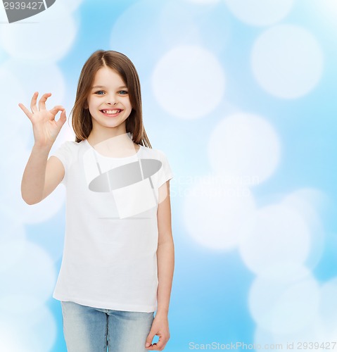 Image of smiling little girl in white blank t-shirt
