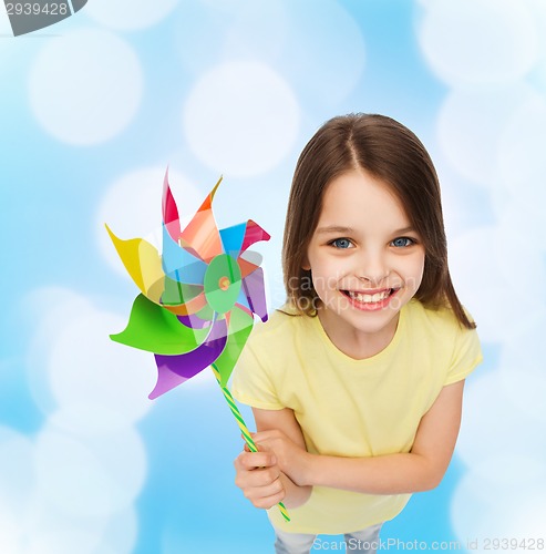 Image of smiling child with colorful windmill toy