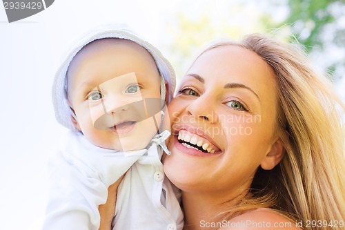 Image of happy mother with little baby outdoors