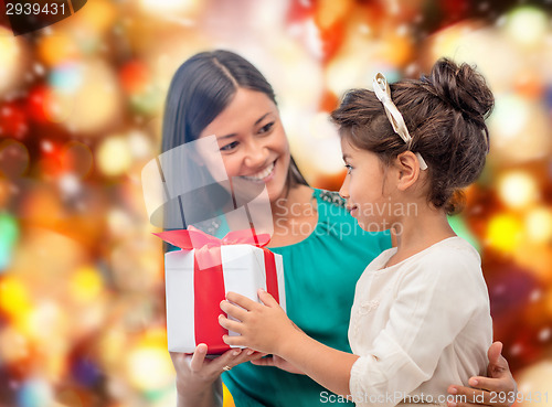 Image of happy mother and child girl with gift box