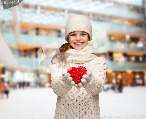 Image of dreaming girl in winter clothes with red heart