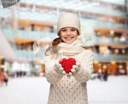 Image of dreaming girl in winter clothes with red heart