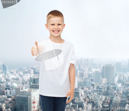 Image of smiling boy in white t-shirt showing thumbs up