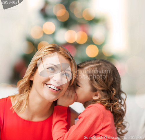 Image of mother and daughter whispering gossip