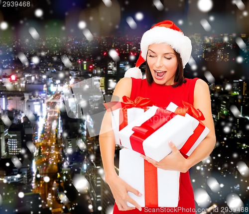 Image of smiling woman in red dress with gift box