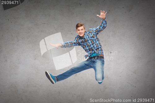 Image of smiling young man jumping in air