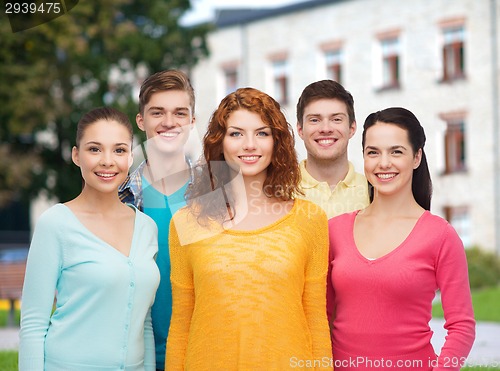 Image of group of smiling teenagers over campus background