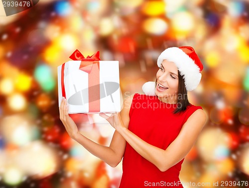 Image of smiling woman in red dress with gift box