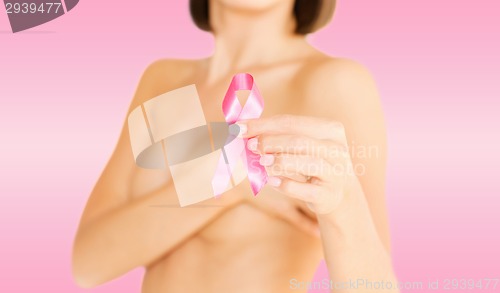 Image of hand holding pink breast cancer awareness ribbon