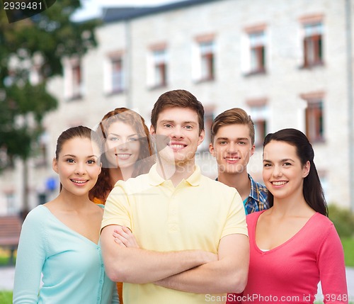 Image of group of smiling teenagers over campus background