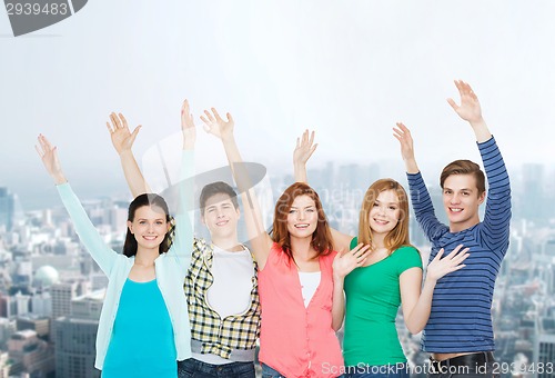 Image of group of smiling students waving hands