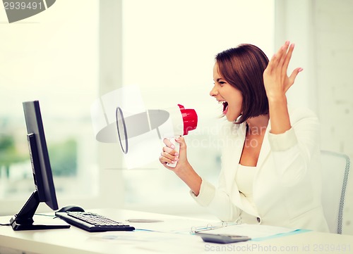 Image of strict businesswoman shouting in megaphone