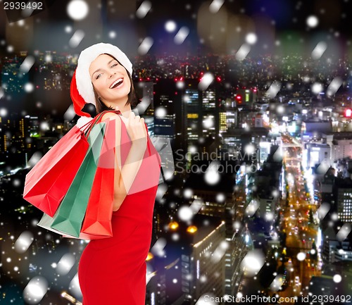 Image of woman in red dress with shopping bags