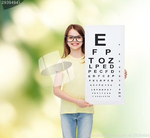 Image of little girl in eyeglasses with eye checking chart