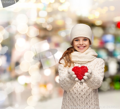 Image of dreaming girl in winter clothes with red heart