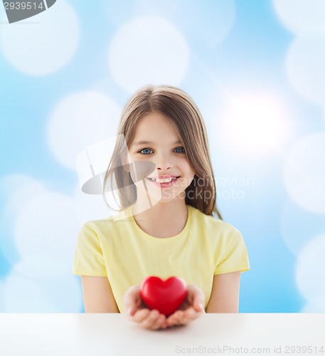 Image of beautiful little girl sitting at table