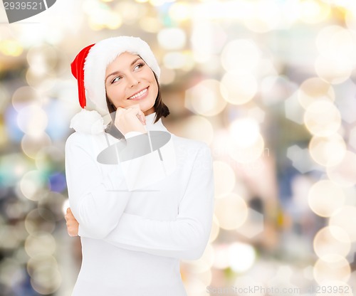 Image of thinking and smiling woman in santa helper hat