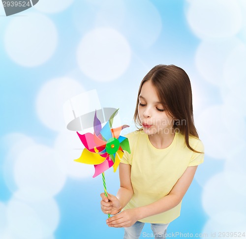 Image of smiling child with colorful windmill toy