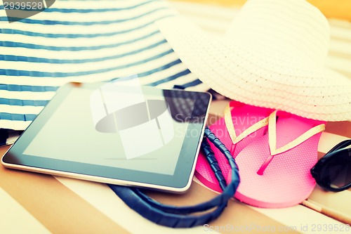 Image of close up of tablet pc on beach