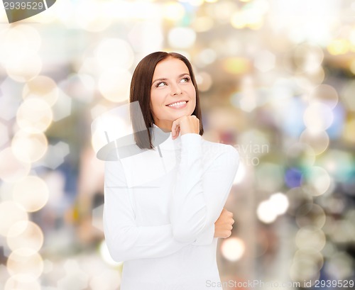 Image of smiling young woman in winter clothes