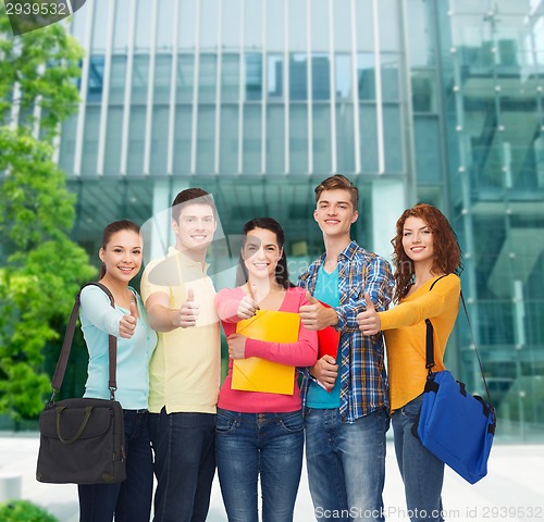 Image of group of smiling teenagers showing thumbs up