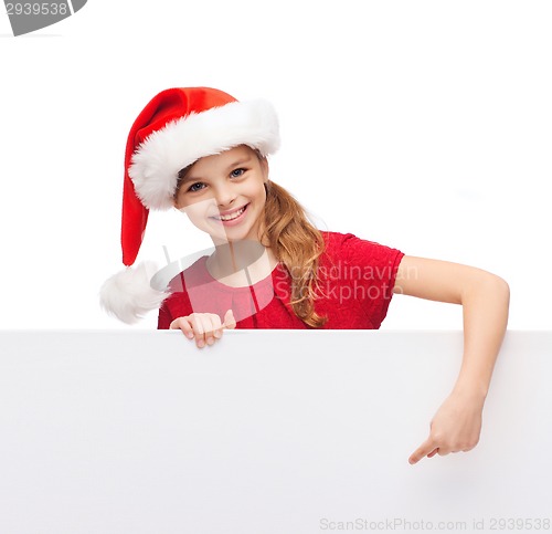 Image of child in santa helper hat with blank white board