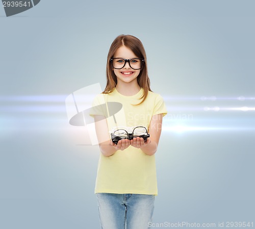 Image of smiling cute little girl in black eyeglasses