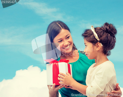 Image of happy mother and child girl with gift box