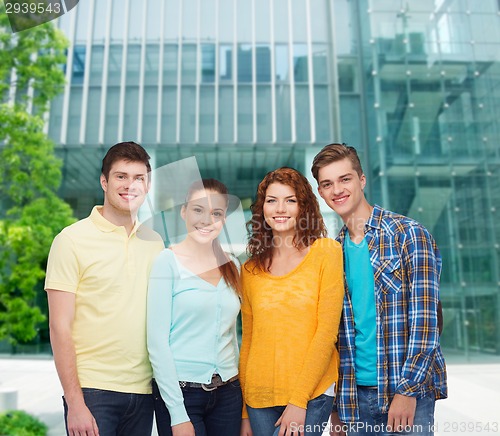 Image of group of smiling teenagers over city background