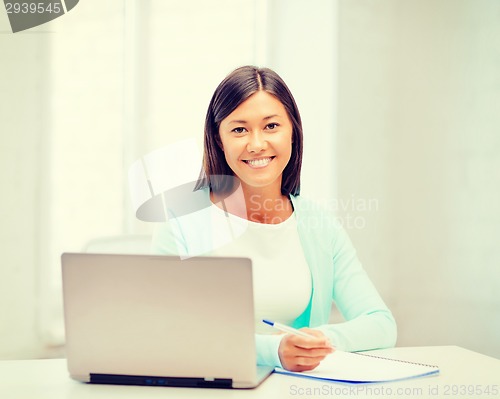 Image of asian businesswoman with laptop and documents
