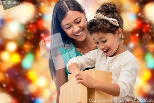 Image of happy mother and child girl with gift box