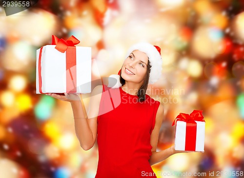 Image of smiling woman in red dress with gift box