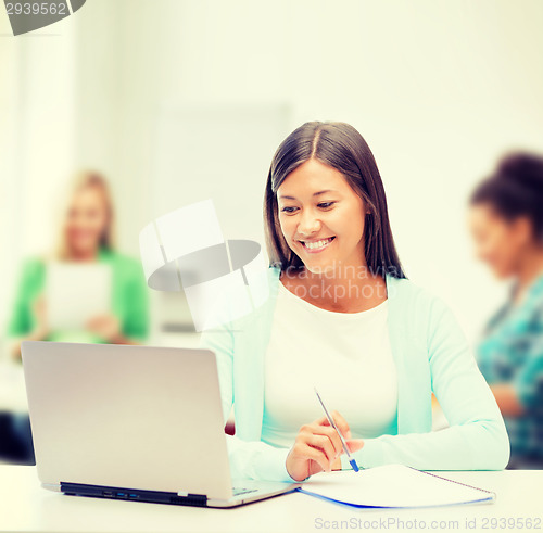 Image of asian businesswoman with laptop and documents