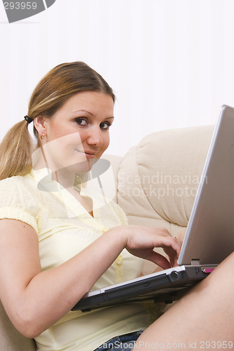 Image of young pretty woman and laptop computer