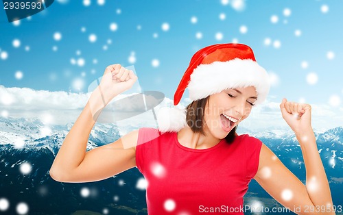 Image of smiling woman in santa helper hat