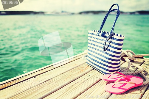 Image of close up of beach accessories on wooden pier