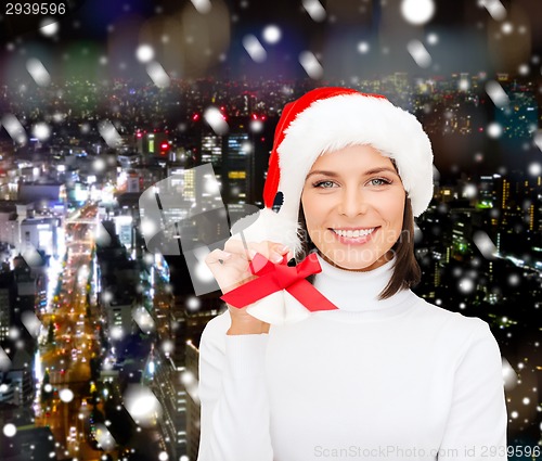 Image of smiling woman in santa helper hat and jingle bells