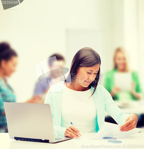 Image of asian businesswoman with laptop and documents