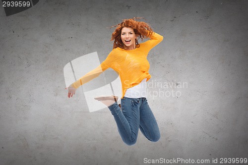 Image of smiling young woman jumping in air